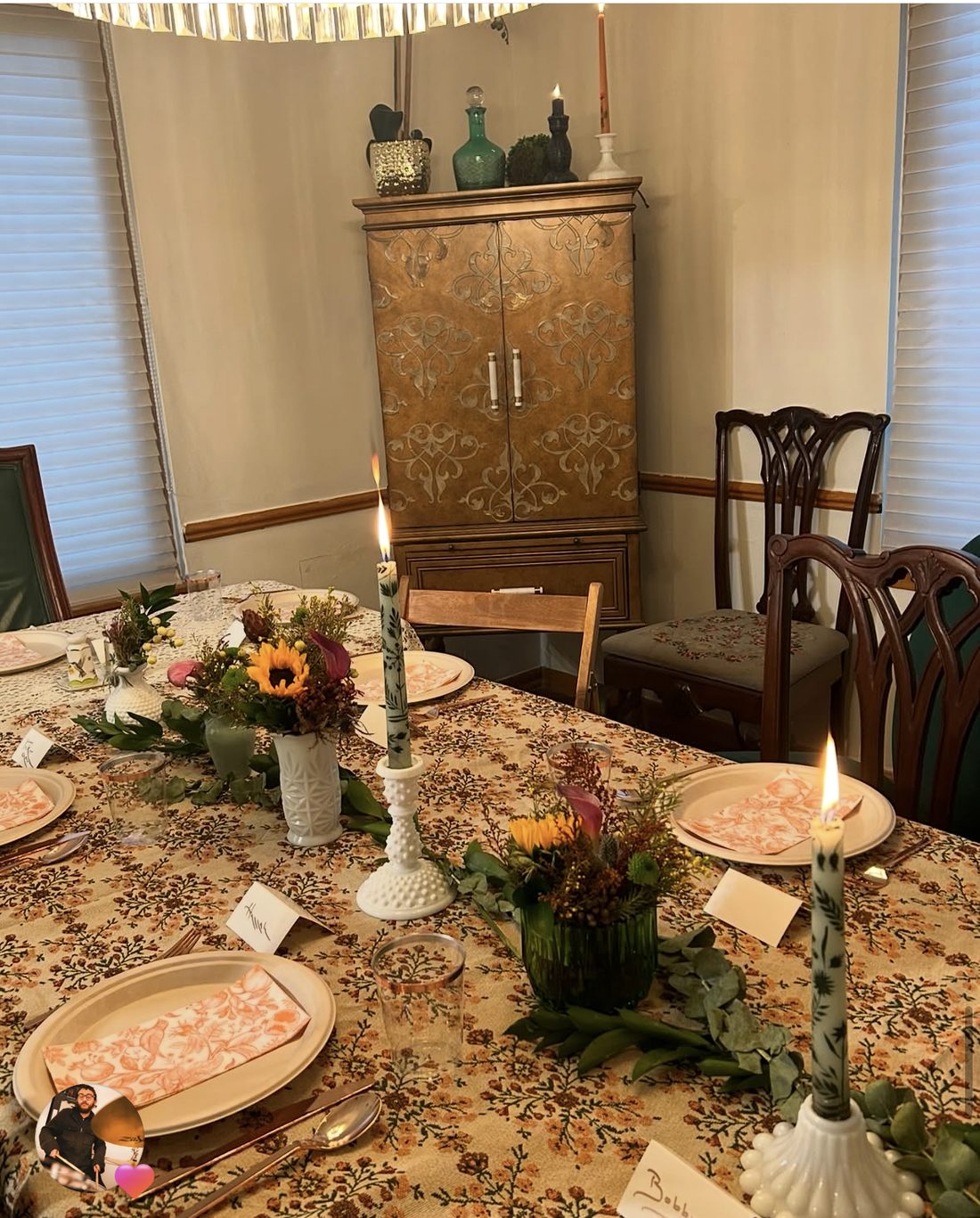 Thanksgiving tablescape with vintage floral linens, milk glass candlesticks and garden centerpieces